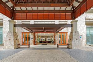 an entrance to a building with two benches at Temple 2 Bedroom Penthouse in Palm Cove