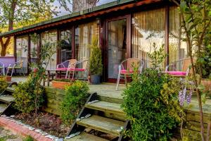a house with pink chairs and a wooden porch at Park Mandalin Hotel - Adult only in Ağva