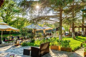 a patio with chairs and tables and umbrellas at Park Mandalin Hotel - Adult only in Ağva
