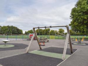 a playground with a swing set in a park at Little London in Bognor Regis