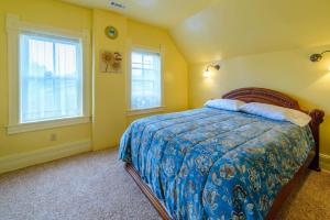a bedroom with a bed and two windows at Panguich Red Brick Homes upper Home in Panguitch