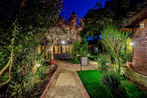 a garden at night with trees and a building at Park Mandalin Hotel - Adult only in Ağva