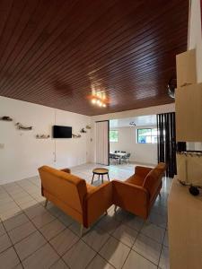 a living room with a couch and a table at CHEZ ANIAKI in Nuku Hiva