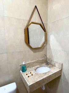 a bathroom with a sink and a mirror at Morada da Ilha Pousada in Soure