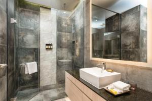 a bathroom with a sink and a shower at Capri by Fraser, Phnom Penh in Phnom Penh