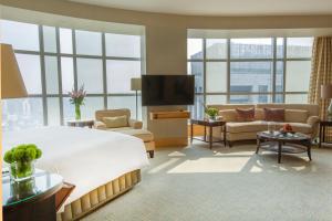 a hotel room with a large bed and a living room at The Ritz-Carlton Beijing, Financial Street in Beijing