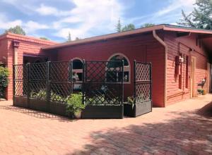 a red building with a gate in front of it at Artsy, Upscale Casita, Walk to Trails, Mountain Views, Guest Guide in Sedona