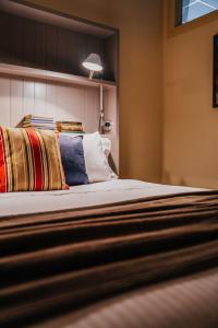 a bedroom with a large bed with colorful pillows at Mister Rice in Castlemaine