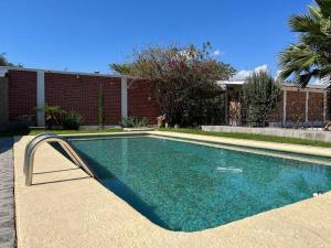 a swimming pool in front of a brick building at Casa San Pedro in San Pedro Tesistán