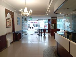 a lobby of a store with a chandelier at Gran Hotel Augusto in Mar del Plata