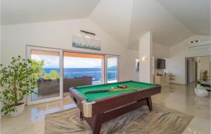a pool table in a room with a view of the ocean at Awesome Home In Crnja Luka With Kitchen in Prigradica