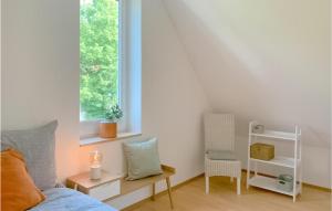 a bedroom with a bed and a window and a chair at Beautiful Home In Morschen With Wifi in Morschen
