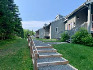 a path leading to a row of houses at Le Rétro Chic à Mont-Tremblant in Mont-Tremblant