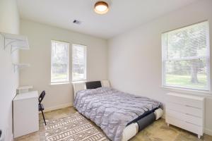a bedroom with a bed and two windows at Airy Dayton Vacation Home with Deck and Private Yard! in Dayton