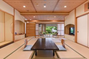 a dining room with a table and chairs at Furuya Ryokan in Atami