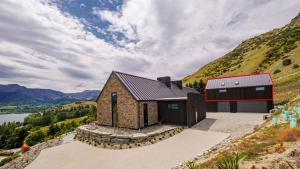 a house on top of a hill with a view at The Loft at Sicilian in Queenstown