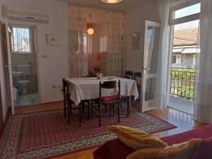 a dining room with a table and some chairs at Apartments Slavica - free WiFi in Vodice