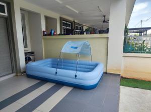 a blue inflatable couch sitting on a balcony at homestay sayangku islam 4 bilik in Segamat