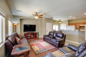 a living room with leather furniture and a flat screen tv at Las Vegas Vacation Rental with Pool Access in Las Vegas