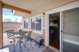 a patio with a table and chairs and a sliding glass door at Las Vegas Vacation Rental with Pool Access in Las Vegas