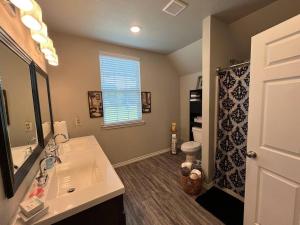 a bathroom with a sink and a mirror at ComfyStay in Gladewater