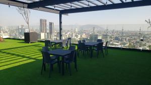 a group of tables and chairs on the roof of a building at Ecovergel Santa Lucia in Monterrey