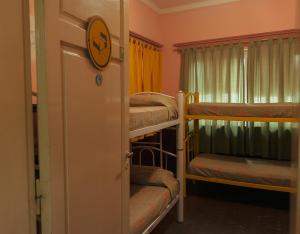 a room with three bunk beds and a door at Hostel Trotamundos in San Rafael