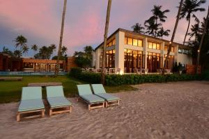 a building with three lounge chairs in front of it at Wendy the Pool Resort @ Koh Kood in Ko Kood