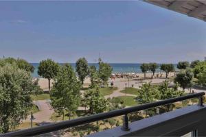a view of a park with trees and the ocean at Beach Apartment with Seaview II in Olympic Beach