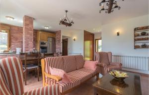 a living room with two chairs and a table at Pet Friendly Home In Pravia With Kitchen in Pravia