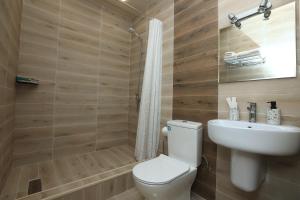 a bathroom with a toilet and a sink at Syune Mini Hotel in Gyumri