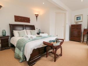 a bedroom with a large bed with towels on it at Fawcet House in Whitby