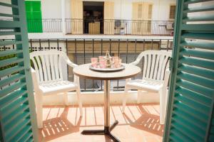 a table and two chairs on a balcony at Hostal Sunset Ibiza in San Antonio