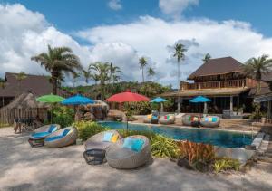 a resort with a swimming pool with chairs and umbrellas at Tinkerbell Resort @ Koh Kood in Ko Kood