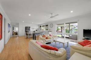 a living room with two couches and a table at Cowes Family Haven in Cowes