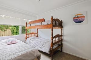 a bedroom with two bunk beds in a room with a window at Cowes Family Haven in Cowes