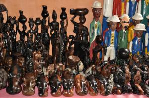 a group of wooden figurines sitting on a table at Hotel Napoleon Lagune in Lom&eacute;