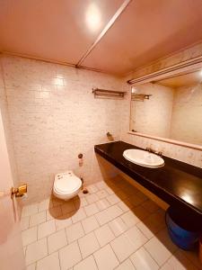 a bathroom with a sink and a toilet at SAGAR RESORT JUST 5 MiN FROM MANALI MALL ROAD in Manāli