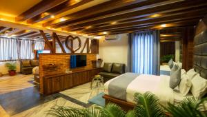 a bedroom with a bed and a tv and a couch at Kumari Star Inn in Pokhara