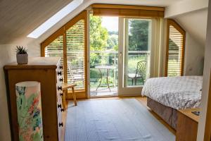 a bedroom with a bed and a sliding glass door at Minafon in Newport