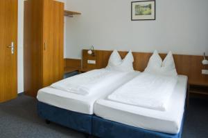 Un pat sau paturi într-o cameră la Gästehaus zur Kurve