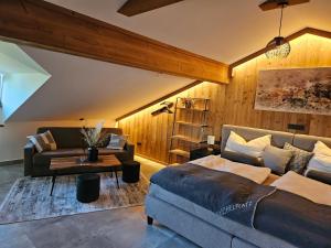 a living room with a bed and a couch at Bauernhof-Loft Edtgut in Guggenthal