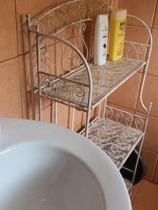 a metal rack with two rolls of toilet paper on it at Aphrodite's hidden gem on Paxos island in Velianitátika