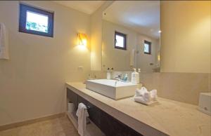 a bathroom with a sink and a large mirror at Charming 4 BR Apartment with Breathtaking Views in Durango