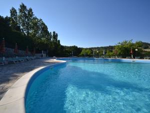a large swimming pool with blue water at Holiday Home in Mattinata with Pool Tennis Court Bikes in Mattinata
