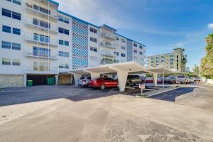 a parking lot in front of a large building at Oceanfront Satellite Beach Condo with Balcony, Views in Satellite Beach