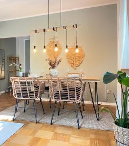 a dining room with a table and chairs at Boho Style Apartment - Messe - Rüttenscheid in Essen