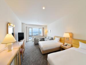 a hotel room with two beds and a television at Hakodate Kokusai Hotel in Hakodate +111 photos