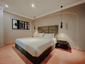 a bedroom with a large bed in a room at Mikaella Hotel in San Miguel de Allende