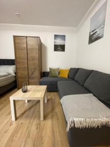a living room with a couch and a coffee table at Route 7 Rooms in Myślenice